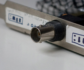 BNC connector (socket/inner) on an old network card (the plastic thread is meant for a fastening ring and is not part of BNC(verify))